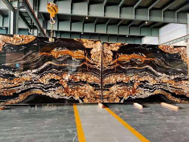 Black magma granite bookmatched with cloudy veins