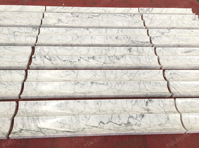 curved statuarietto marble fireplace tiles
